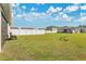Expansive backyard with lush lawn, white vinyl fence, and ample space for outdoor activities at 1507 Bitteroot St, Kissimmee, FL 34744