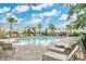 Inviting community pool surrounded by lounge chairs and lush landscaping in a residential area at 1507 Bitteroot St, Kissimmee, FL 34744