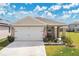Charming one-story home with a two car garage and manicured lawn at 1507 Bitteroot St, Kissimmee, FL 34744