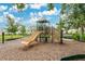 Community playground featuring slides, climbing structures, benches, and a mulch ground cover at 1507 Bitteroot St, Kissimmee, FL 34744