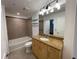 Well-lit bathroom with granite countertops and tiled shower at 155 S Court Ave # 1308, Orlando, FL 32801