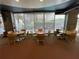 Bright common area with multiple tables and chairs, ideal for casual meetings or relaxation near large windows at 155 S Court Ave # 1308, Orlando, FL 32801