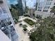 Urban courtyard with patterned stone, lush green landscaping, and seating areas at 155 S Court Ave # 1308, Orlando, FL 32801