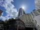 Urban building with modern architectural design on a sunny day, with sun flair, in a commercial area at 155 S Court Ave # 1308, Orlando, FL 32801