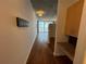 Hallway with laminate flooring, built in desk and view into the living room and balcony at 155 S Court Ave # 1308, Orlando, FL 32801