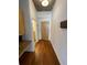 Hallway with bamboo laminate floors, built in desk, and entrances to the bathroom and front door at 155 S Court Ave # 1308, Orlando, FL 32801