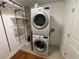 Convenient laundry room with stacked washer and dryer, plus shelving at 155 S Court Ave # 1308, Orlando, FL 32801