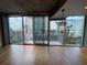 Bright, open living area featuring hardwood floors, a balcony with city views, and modern lighting at 155 S Court Ave # 1308, Orlando, FL 32801