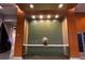 Lobby showcases a decorative wall with a stylish floral arrangement, complemented by warm lighting and sleek surfaces at 155 S Court Ave # 1308, Orlando, FL 32801