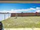 Spacious backyard featuring a well-maintained lawn, bordered by both brick and privacy fencing at 16588 Centipede St, Clermont, FL 34714