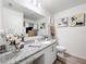 Stylish bathroom with granite countertop, white cabinetry, modern fixtures, and decorative accents at 16588 Centipede St, Clermont, FL 34714