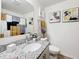Bright bathroom featuring a granite countertop, white cabinetry, and modern decor and stylish fixtures at 16588 Centipede St, Clermont, FL 34714