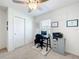 Bright bedroom features a closet with sliding doors, neutral carpet, a ceiling fan, and a comfortable work space at 16588 Centipede St, Clermont, FL 34714