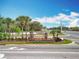 Sawgrass Bay community sign featuring stone pillars, lush landscaping, and a bright blue sky as a backdrop at 16588 Centipede St, Clermont, FL 34714