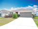 Charming single-story home featuring a two-car garage and well-maintained landscaping at 16588 Centipede St, Clermont, FL 34714