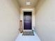 Elegant front door with modern hardware and a welcoming 'Hello Spring' sign at 16588 Centipede St, Clermont, FL 34714