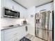 Modern kitchen featuring stainless steel appliances, granite countertops, and white subway tile backsplash at 16588 Centipede St, Clermont, FL 34714