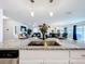 Open-concept design showcasing a kitchen island with granite counters and seating, flowing into the living area at 16588 Centipede St, Clermont, FL 34714