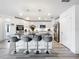 Bright kitchen with granite countertops, stainless steel appliances, and bar stool seating at 16588 Centipede St, Clermont, FL 34714
