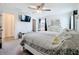 Bright main bedroom with a ceiling fan, TV, and neutral decor creating a serene and inviting space at 16588 Centipede St, Clermont, FL 34714