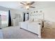 Spacious main bedroom featuring a large bed, ceiling fan, neutral carpet, and multiple dressers at 16588 Centipede St, Clermont, FL 34714
