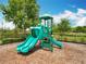 A playground features a green play structure with two slides, all in a fenced-in area with wood chip ground cover at 16588 Centipede St, Clermont, FL 34714