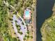 Overhead aerial shot of a community pool and amenities, showcasing a recreational space near green space and water at 16588 Centipede St, Clermont, FL 34714