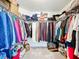Organized walk-in closet with ample hanging space, shelves, and storage for clothing and accessories at 16588 Centipede St, Clermont, FL 34714
