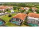 An aerial view of a neighborhood with tile roofs, screened in pools and green lawns at 16621 Caribbean Breeze Way, Clermont, FL 34714