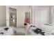 Bright bedroom featuring carpet floors, two beds, and a full-sized closet at 16621 Caribbean Breeze Way, Clermont, FL 34714
