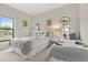 Charming bedroom with two beds, featuring natural light from two windows at 16621 Caribbean Breeze Way, Clermont, FL 34714