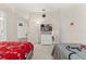 Spacious bedroom featuring carpet floors, two beds, a media center, and a ceiling fan at 16621 Caribbean Breeze Way, Clermont, FL 34714