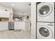 Adjacent kitchen with white countertops, stainless dishwasher, and open flow to the home at 16621 Caribbean Breeze Way, Clermont, FL 34714
