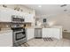 Bright kitchen featuring white cabinets, stainless appliances, and plenty of counter space at 16621 Caribbean Breeze Way, Clermont, FL 34714