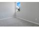 Bright bedroom with neutral carpet, fresh paint, and natural light from the large window at 1737 Carnelian St, Deland, FL 32720