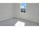 Bright bedroom with neutral carpet, fresh paint, and natural light from the large window at 1737 Carnelian St, Deland, FL 32720