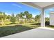 Back yard featuring landscaping and green space, as seen from under a covered porch at 1741 Carnelian St, Deland, FL 32720