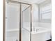 Bright bathroom featuring a soaking tub, a glass shower, and white subway tile at 1741 Carnelian St, Deland, FL 32720