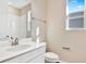 Bright bathroom with white vanity, marble countertop, silver faucet, and white tiled shower near a sunlit window at 1741 Carnelian St, Deland, FL 32720