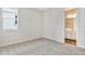 Neutral bedroom with carpet and a window, showing the doorway to an ensuite bathroom at 1741 Carnelian St, Deland, FL 32720
