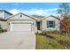 Charming one-story home features a gray stucco exterior, two-car garage, and simple, attractive landscaping at 1741 Carnelian St, Deland, FL 32720