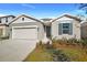 Charming one-story home features a gray stucco exterior, two-car garage, and simple, attractive landscaping at 1741 Carnelian St, Deland, FL 32720