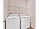 Functional laundry room featuring a side-by-side washer and dryer with storage shelf above at 1741 Carnelian St, Deland, FL 32720