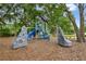 Community playground offers a safe and engaging outdoor play experience surrounded by a canopy of mature trees at 1741 Carnelian St, Deland, FL 32720