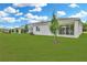 Spacious backyard with lush green lawn and neatly trimmed trees, perfect for outdoor activities at 1747 Carnelian St, Deland, FL 32720