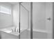 Elegant bathroom featuring a separate soaking tub and glass-enclosed shower with white tiling at 1747 Carnelian St, Deland, FL 32720