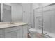 Bright bathroom with a vanity, sink, toilet and a separate glass-enclosed shower at 1747 Carnelian St, Deland, FL 32720