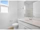 Modern bathroom featuring white cabinetry, quartz countertops, and a shower with glass doors at 1747 Carnelian St, Deland, FL 32720