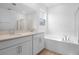 Modern bathroom featuring double sinks, a soaking tub, and a separate glass-enclosed shower at 1747 Carnelian St, Deland, FL 32720