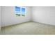 Bright bedroom with plush carpeting and a window offering views of the neighborhood at 1747 Carnelian St, Deland, FL 32720